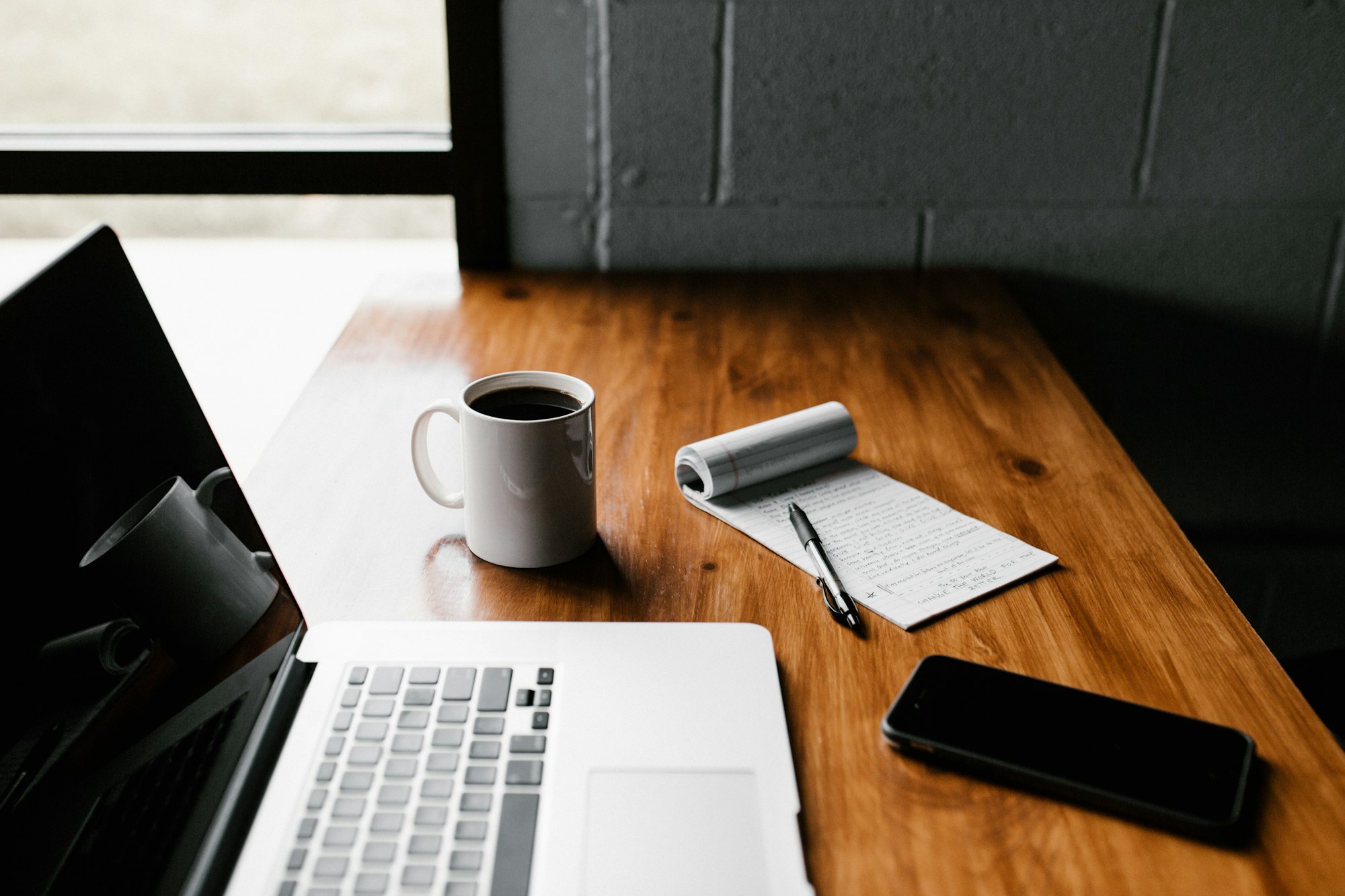 Workspace with notebook and laptop for ASCA Audit and Advisory blog